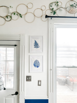 Hand drawn blue fern print in white and blue kitchen with plants