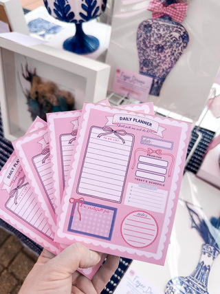 Daily planner with various sections on a pink background scalloped border cute pretty dopamine coquette cutesy day to-do list notebook adhd friendly checklist life hack kawaii small business bows mental health journal gratitude practice Daily planner with sections 