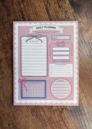 Daily planner with various sections on a pink background scalloped border cute pretty dopamine coquette cutesy day to-do list notebook adhd friendly checklist life hack kawaii small business bows mental health journal gratitude practice 