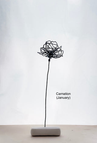 A cluster of three silver wire flowers with intricate, openwork petals. The stems are long and slender, and the flowers are arranged in a bouquet. The background is a solid, dark blue. carnation January birth flower preserved florals Mother’s Day gifts gift for mom silver and black wire flowers delicate pretty decor wedding floral preservation forver flowers wire flower stem carnations curved leaf handmade small business steel aluminum petals dried florals whimsical decor