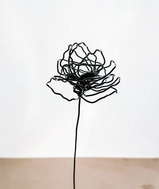 A cluster of three silver wire flowers with intricate, openwork petals. The stems are long and slender, and the flowers are arranged in a bouquet. The background is a solid, dark blue. carnation January birth flower preserved florals Mother’s Day gifts gift for mom silver and black wire flowers delicate pretty decor wedding floral preservation forver flowers wire flower stem carnations curved leaf handmade small business steel aluminum petals dried florals whimsical decor