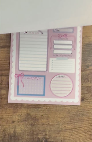 Daily planner with various sections on a pink background scalloped border cute pretty dopamine coquette cutesy day to-do list notebook adhd friendly checklist life hack kawaii small business bows mental health journal gratitude practice 